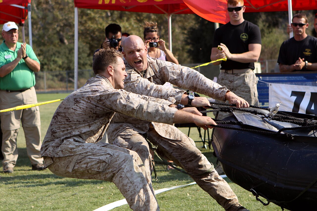 120915-M-LD192-564 U.S. Marine Corps Master Sgt. Christopher May and Sgt. Mark Rawson use the last of their energy reserves to drag a 250-pound Zodiac