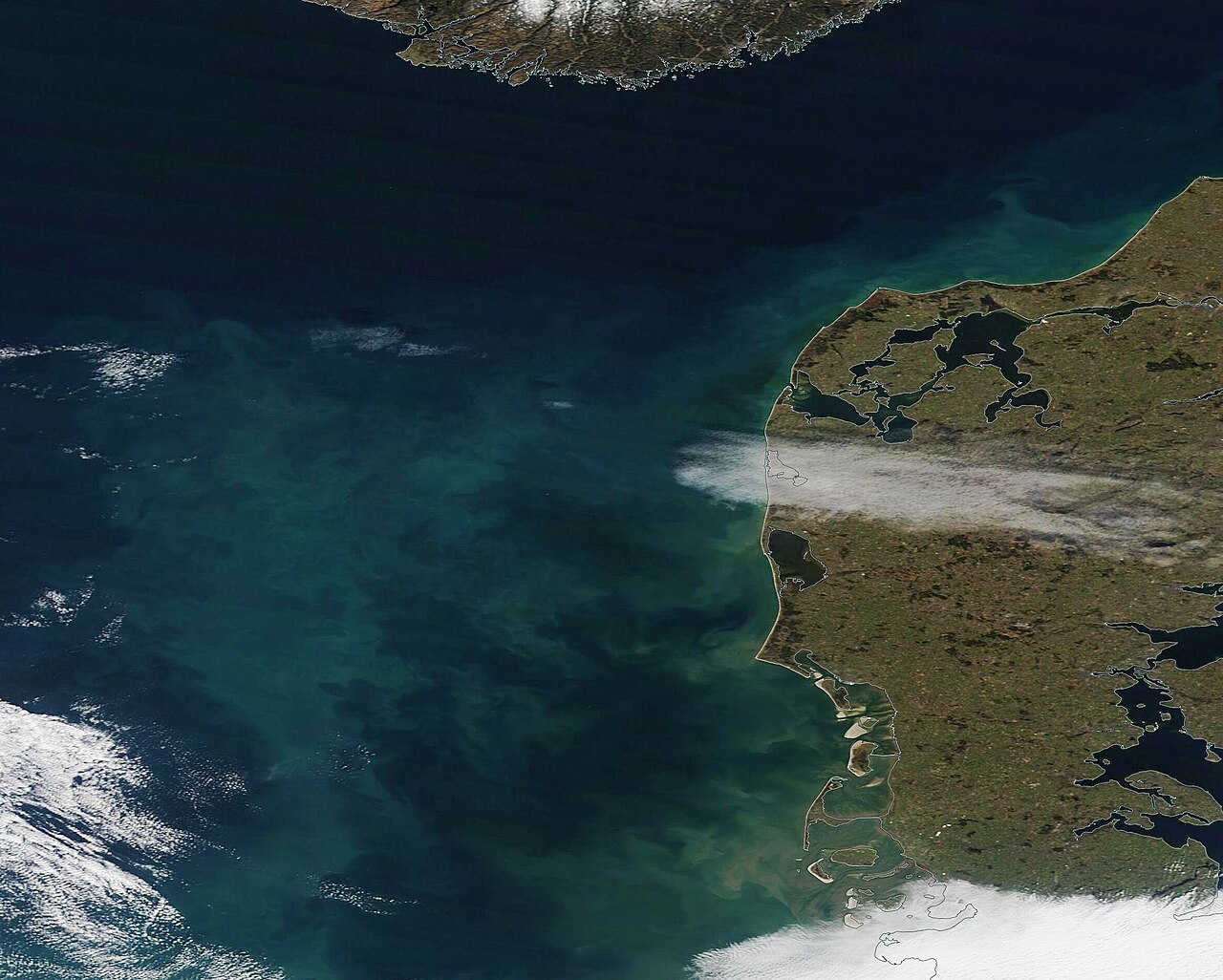 The waters of the North Sea were tinted with tones of green and tan in early March 2023. The Moderate Resolution Imaging Spectroradiometer (MODIS) on 